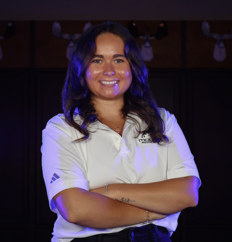 A confident team member from an Omaha roofing company in branded attire.
