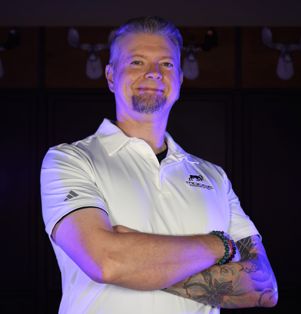 Confident Omaha roofing expert in a white polo shirt with logo.