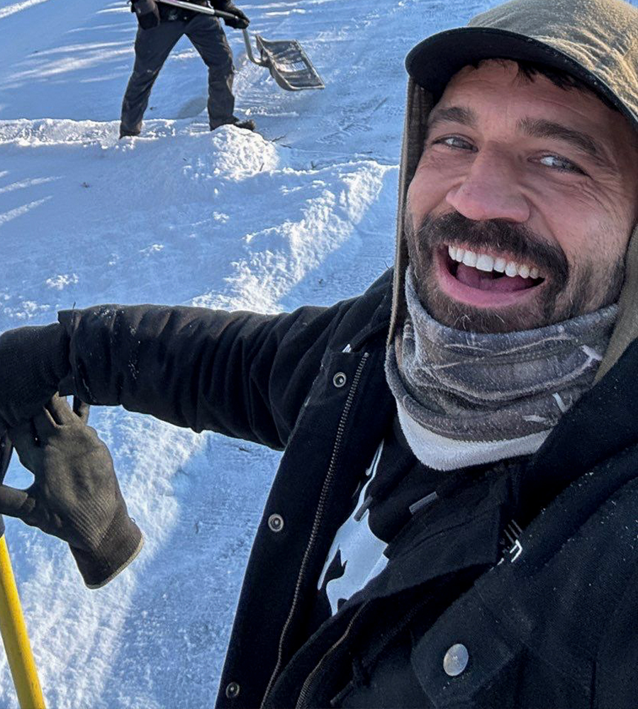 Anthony Pflug on a snow covered roof
