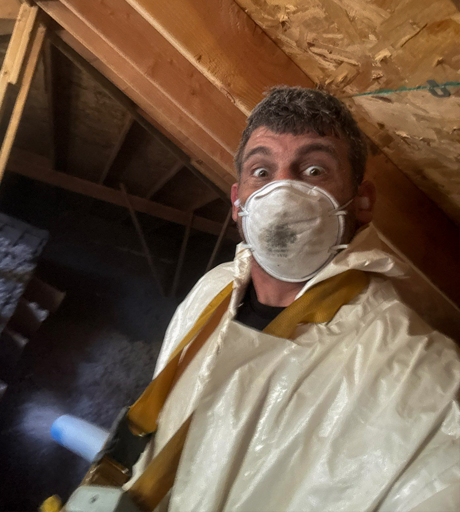 Anthony wearing a mask in an attic during a service