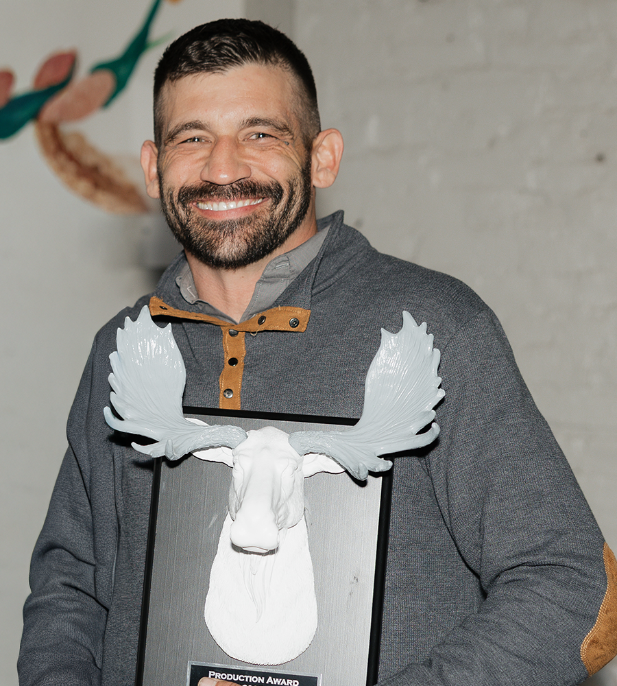 Anthony Pflug holding silver antlers at a party