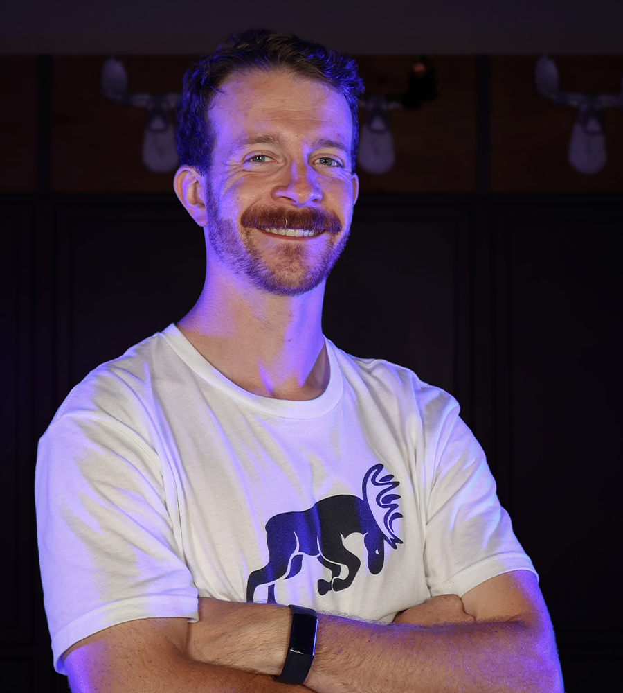 Mark Powell posing for the camera in a Moose Roofing shirt