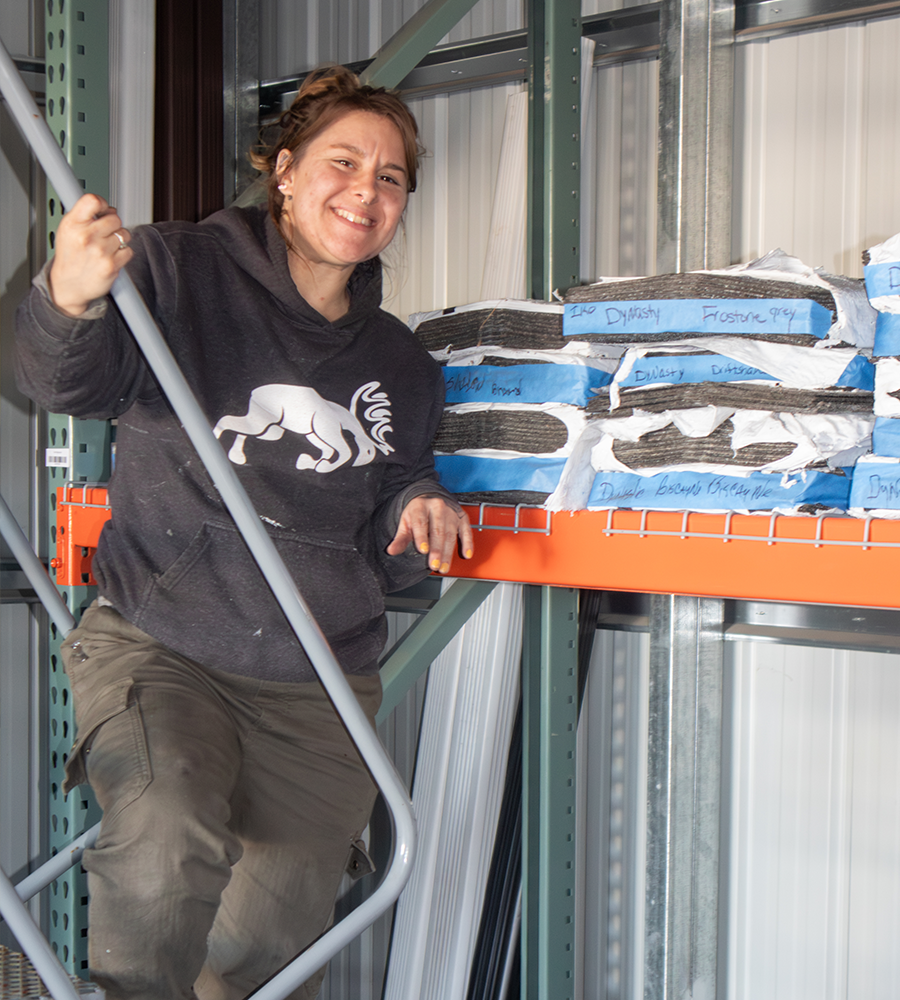 Laura standing near a stack of shingles