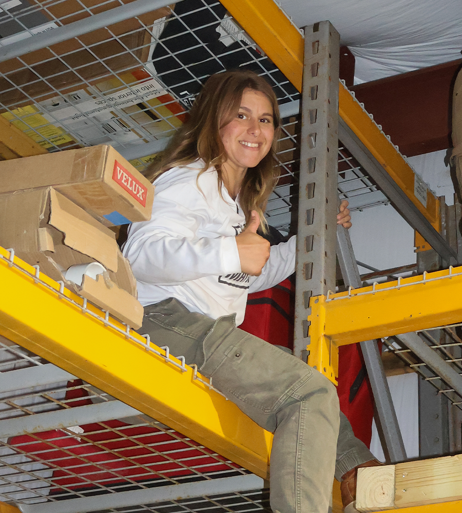 Laura Vanderpool sitting on the shelf with a thumbs up