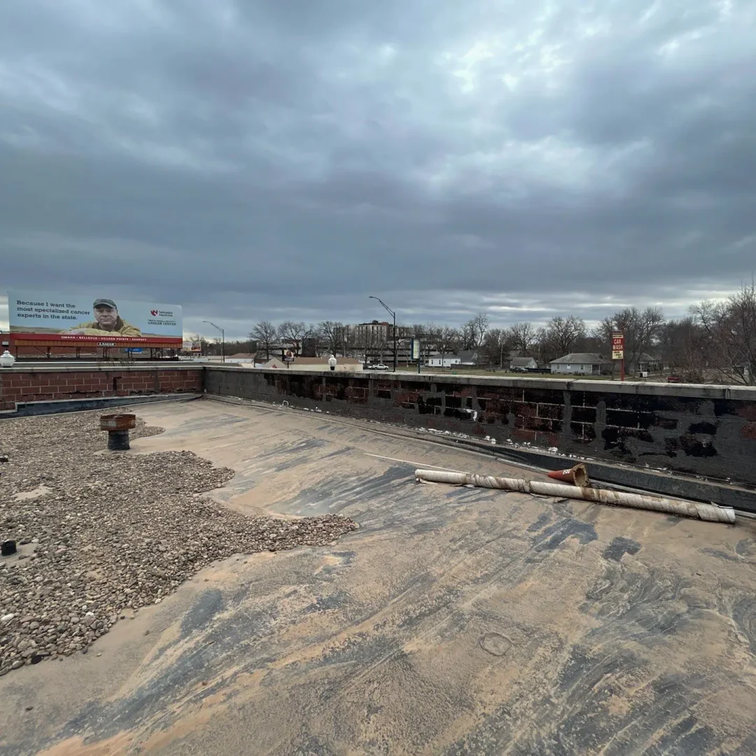 Flat rooftop under a cloudy sky with urban surroundings in Omaha.