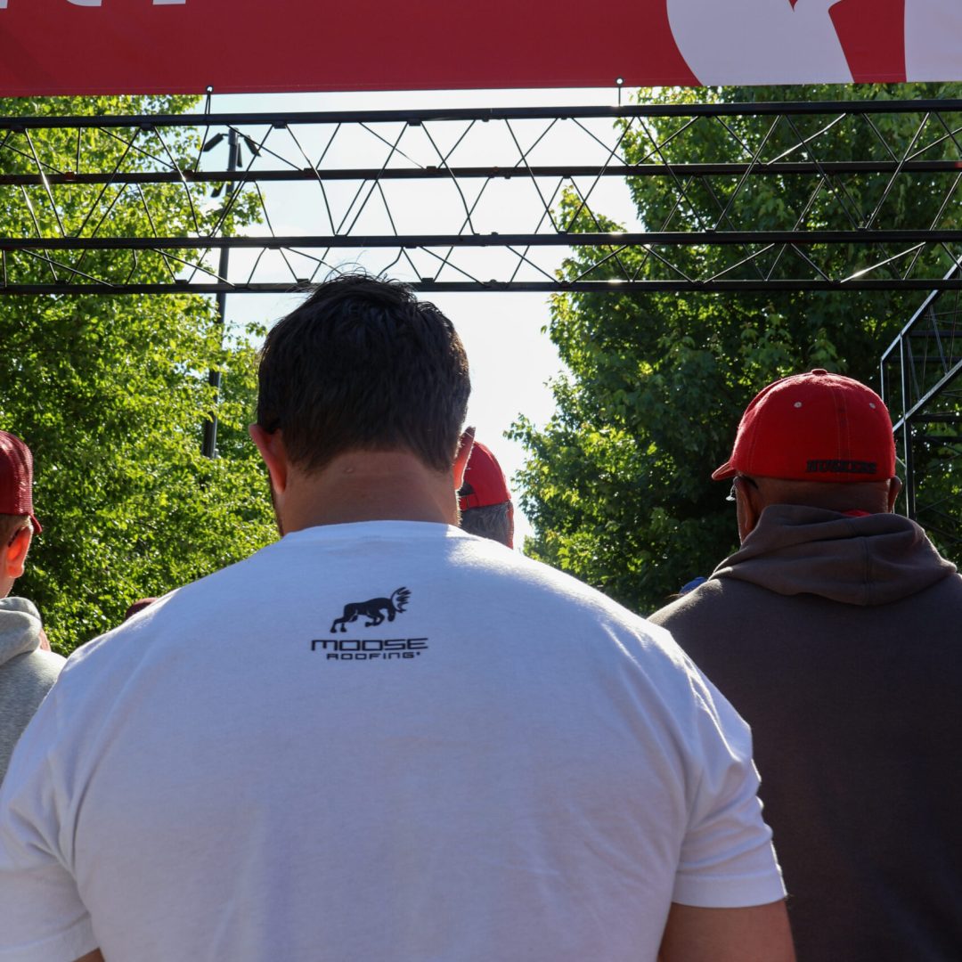 People at a Heart Walk event wearing Omaha roofing company shirts.