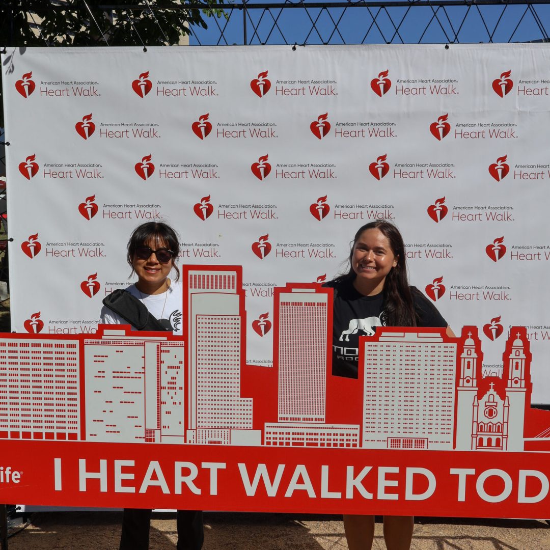 Two women smiling at the American Heart Association Heart Walk event in Omaha.