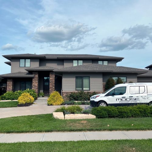 Local Wichita roofing team working on a steep residential roof