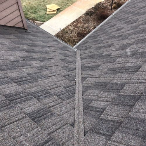 A newly installed shingle roof with a detailed view of roof valley construction.